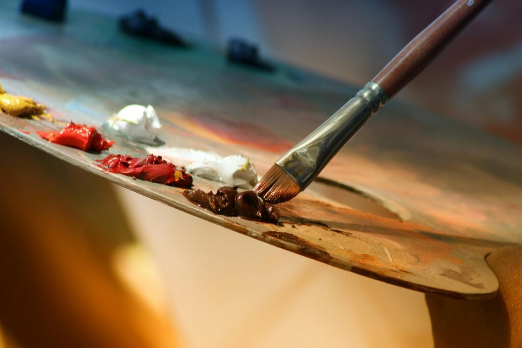 pexels-photo-102127-102127 Vibrant artist palette with paint and brush creating colorful artwork.